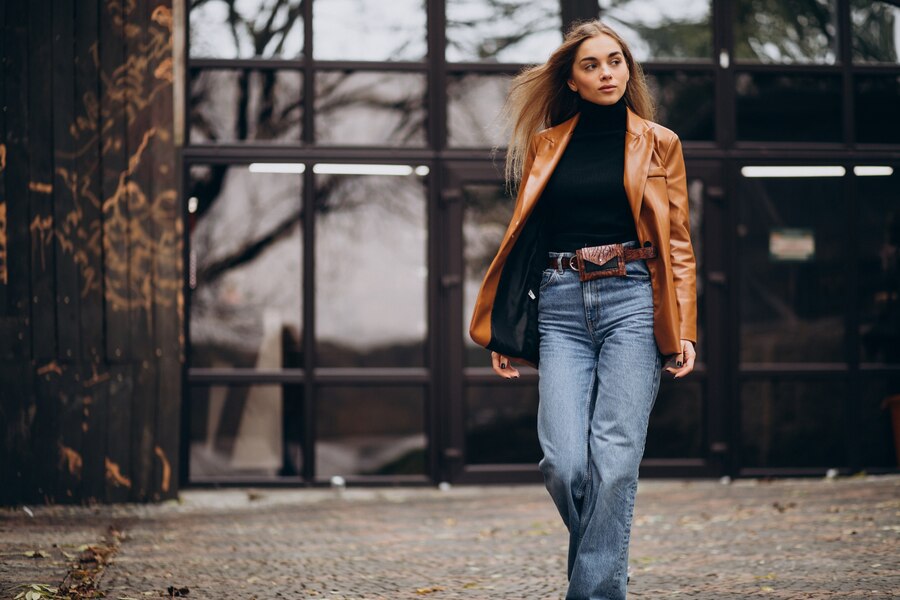 Stylish brown leather jacket on a hanger, showcasing its classic design.